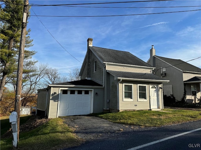 view of side of home with a garage and a yard