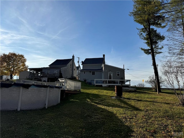 view of yard with a pool side deck