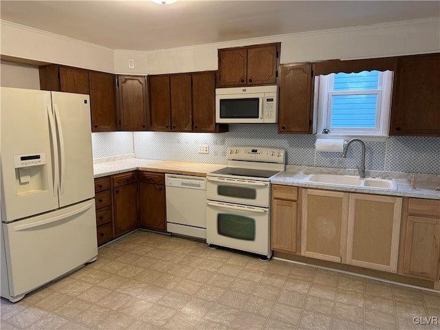 kitchen featuring tasteful backsplash, crown molding, sink, and white appliances