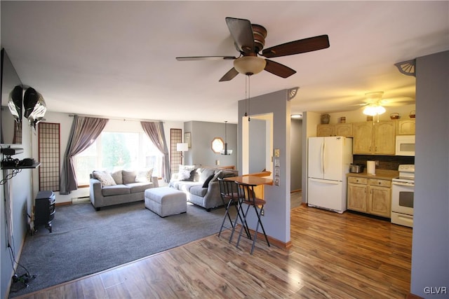 living room featuring dark hardwood / wood-style flooring, baseboard heating, and ceiling fan