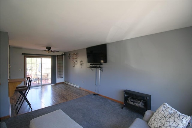 living room featuring hardwood / wood-style floors, baseboard heating, and ceiling fan