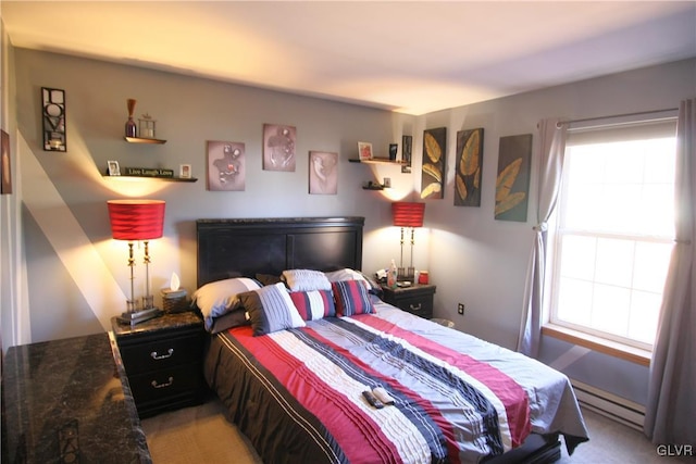 bedroom with light colored carpet and a baseboard radiator