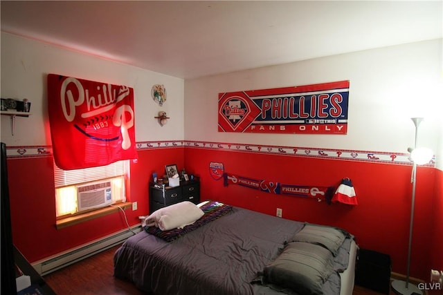 bedroom with cooling unit, a baseboard radiator, and hardwood / wood-style flooring