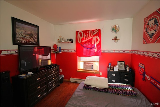 bedroom with hardwood / wood-style floors, cooling unit, and a baseboard heating unit