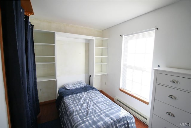 bedroom featuring dark hardwood / wood-style flooring and a baseboard radiator