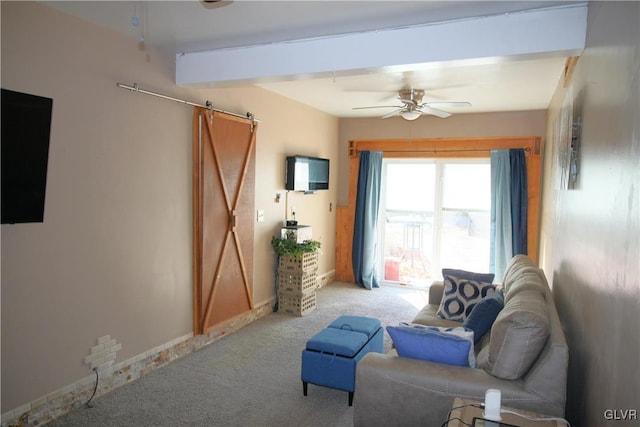 living room featuring beam ceiling, a barn door, ceiling fan, and light colored carpet