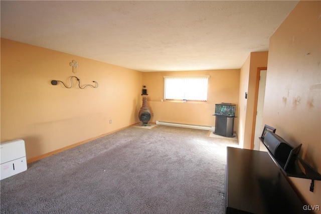 unfurnished living room with carpet flooring and a baseboard heating unit