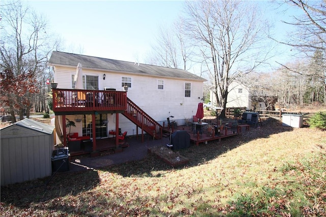 back of house with a storage unit, a lawn, and a wooden deck