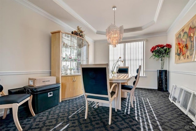 carpeted dining area with plenty of natural light, ornamental molding, and a tray ceiling