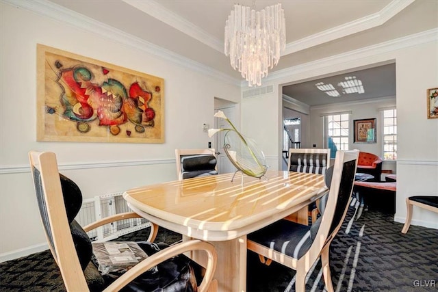 dining room with dark carpet, a notable chandelier, and ornamental molding