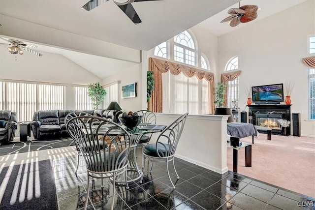 carpeted dining room with vaulted ceiling