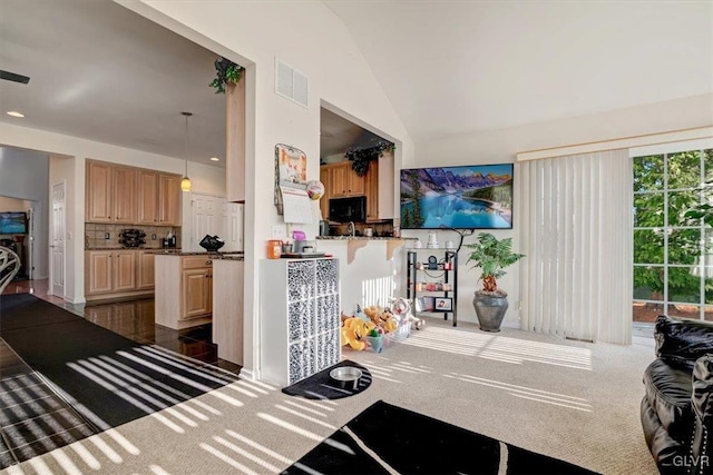 interior space with dark carpet and vaulted ceiling