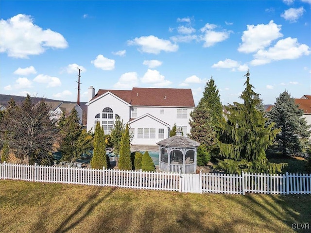 view of front of home featuring a gazebo and a front lawn