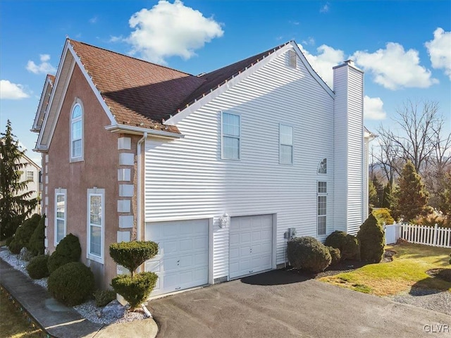 view of side of property with a garage