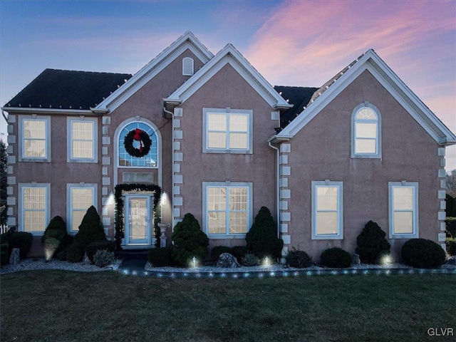 view of property featuring a lawn