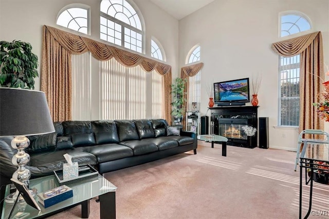 living room featuring carpet flooring and a towering ceiling