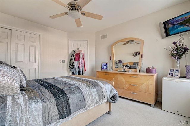 carpeted bedroom featuring a closet and ceiling fan