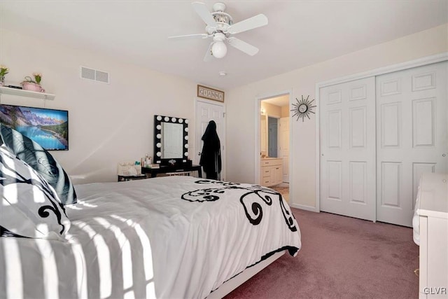 carpeted bedroom with a closet, ensuite bath, and ceiling fan