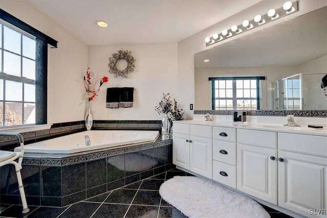 bathroom featuring tile patterned floors, independent shower and bath, vanity, and a healthy amount of sunlight