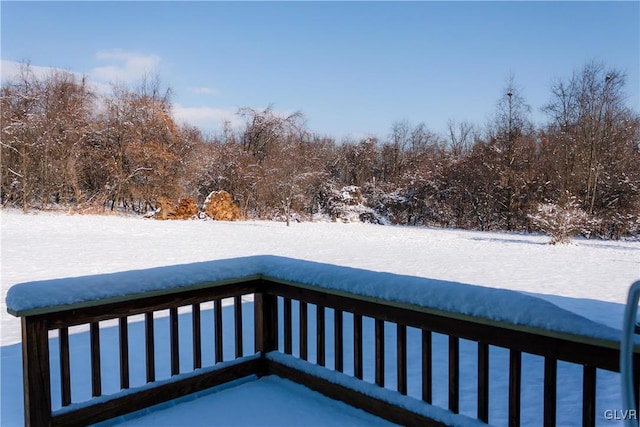 view of snow covered back of property