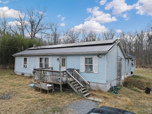 manufactured / mobile home featuring solar panels, a deck, and cooling unit