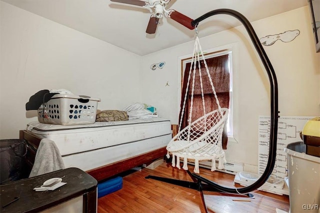 bedroom with ceiling fan and wood-type flooring