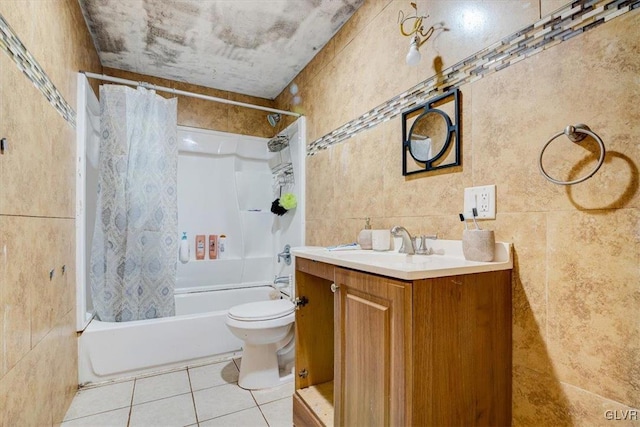 full bathroom with tile patterned floors, vanity, shower / tub combo with curtain, tile walls, and toilet