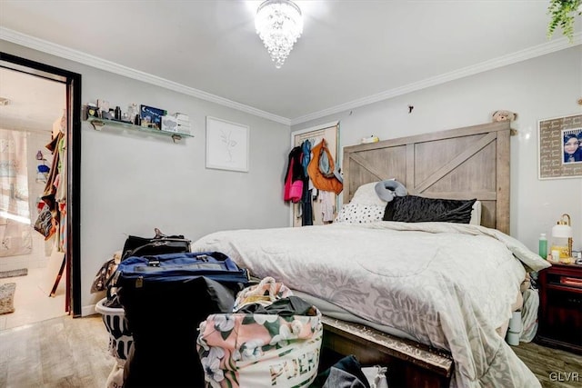 bedroom featuring crown molding and hardwood / wood-style flooring