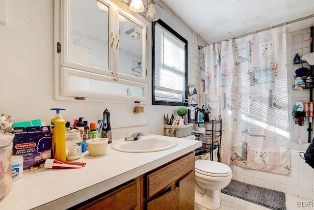 bathroom with tile patterned flooring, vanity, and toilet