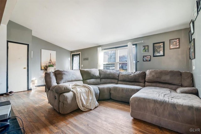 living room featuring hardwood / wood-style floors and lofted ceiling