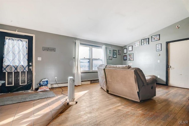 living room featuring wood-type flooring, lofted ceiling, and a baseboard radiator