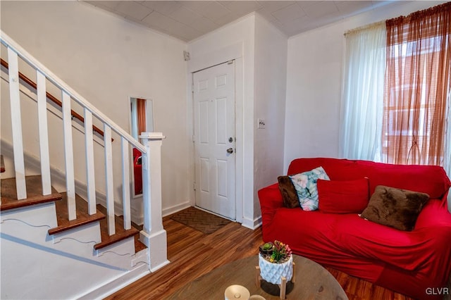 living room with crown molding and dark hardwood / wood-style floors