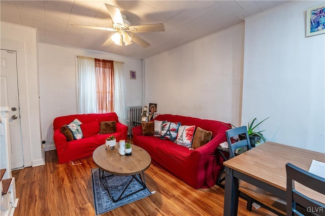 living room with ceiling fan, hardwood / wood-style floors, and ornamental molding