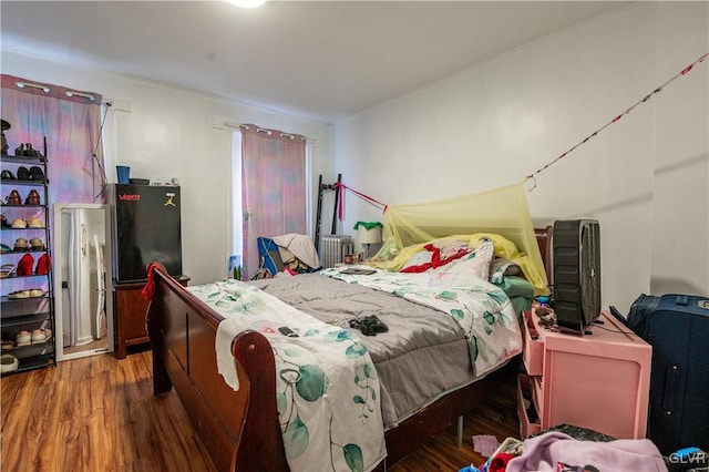 bedroom with dark wood-type flooring