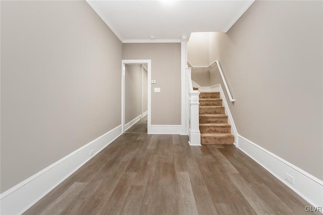 stairs featuring crown molding and hardwood / wood-style flooring