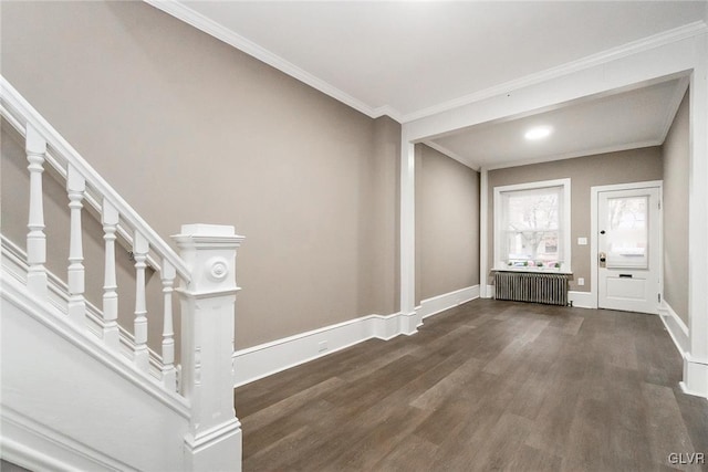 entrance foyer with dark hardwood / wood-style floors, radiator heating unit, and crown molding