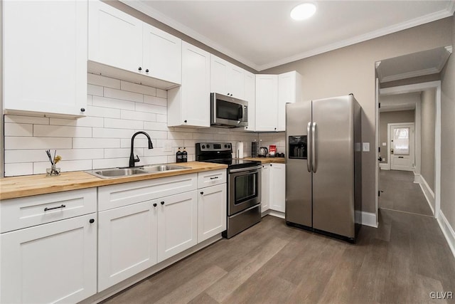 kitchen featuring white cabinetry, sink, dark hardwood / wood-style floors, butcher block countertops, and appliances with stainless steel finishes