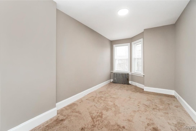 carpeted spare room with radiator