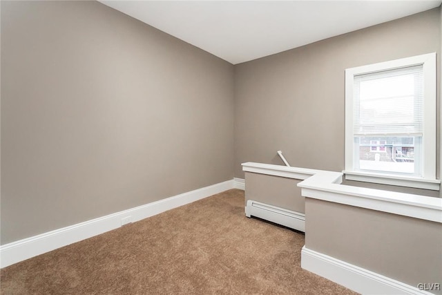 empty room with light carpet and a baseboard radiator