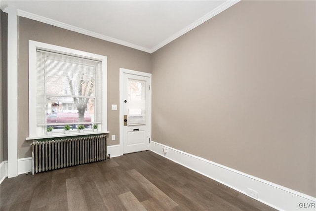 unfurnished room with dark hardwood / wood-style floors, radiator, and crown molding