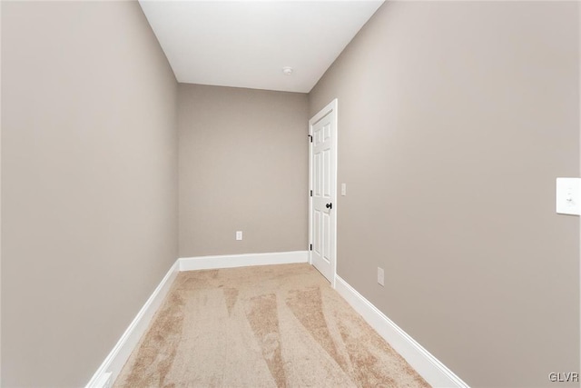 spare room featuring light colored carpet