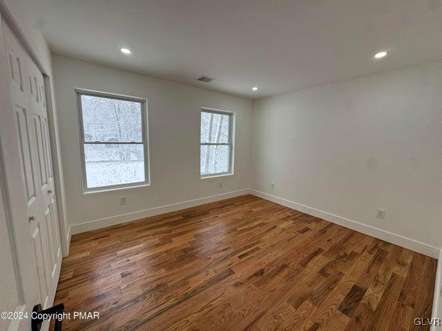 spare room featuring hardwood / wood-style flooring