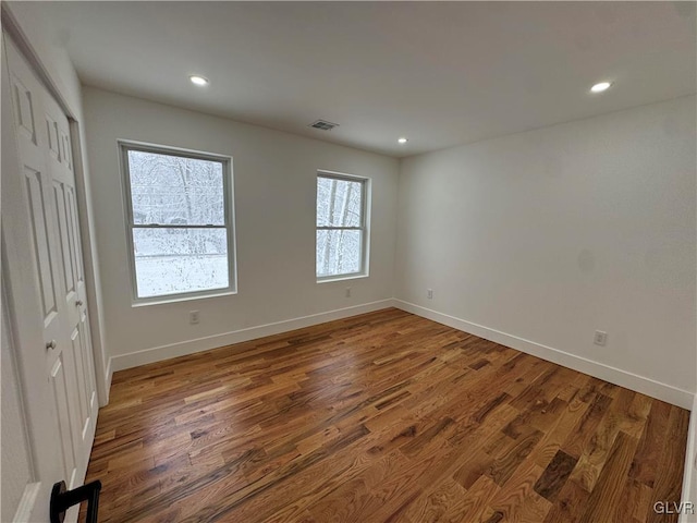 spare room with wood-type flooring