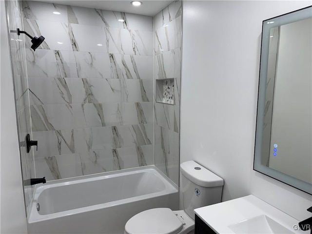 full bathroom with vanity, tiled shower / bath combo, and toilet