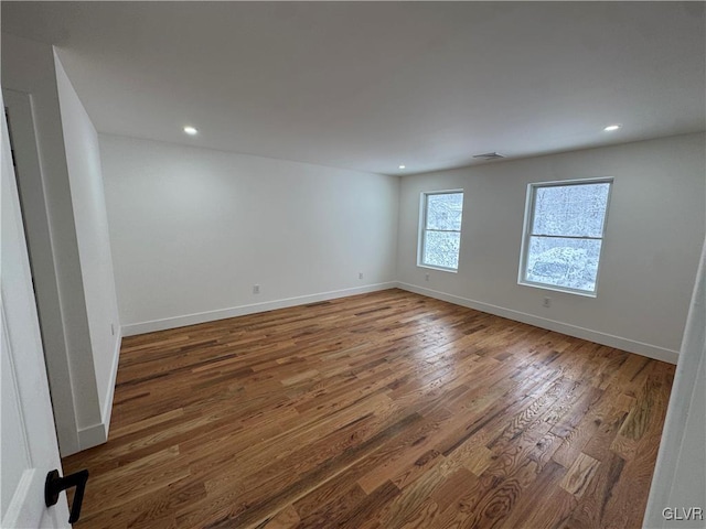 spare room with dark hardwood / wood-style flooring