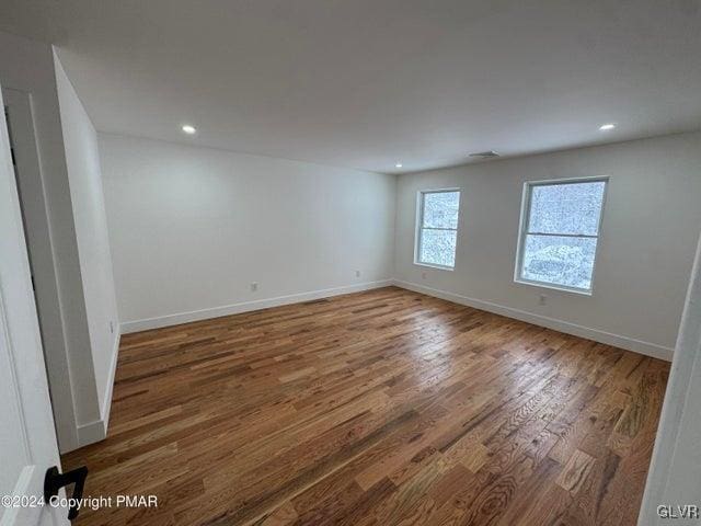 unfurnished room with wood-type flooring