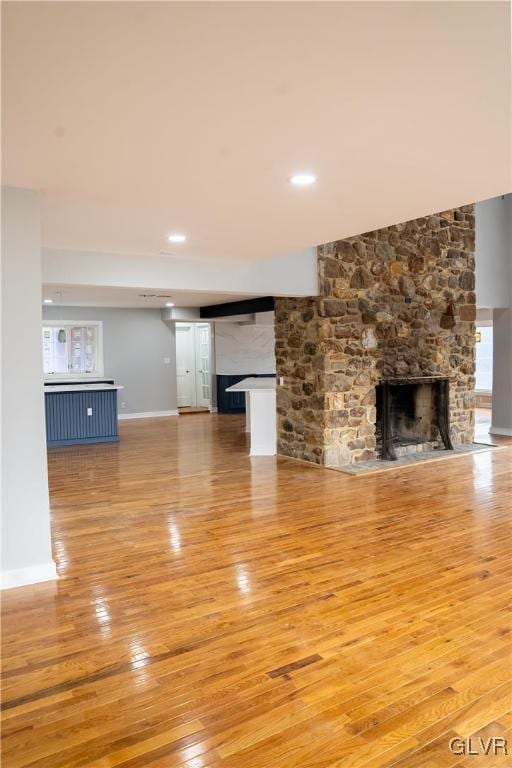 unfurnished living room featuring hardwood / wood-style floors and a fireplace