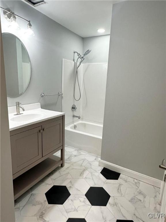 bathroom with vanity and bathing tub / shower combination