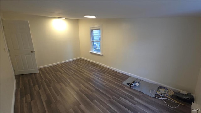 spare room with dark hardwood / wood-style flooring