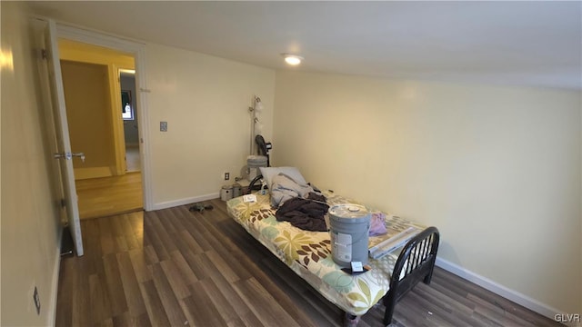 bedroom with dark hardwood / wood-style flooring